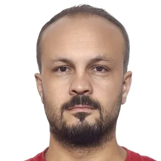 Portrait of Ercan Bayak facing forward against a plain white background.