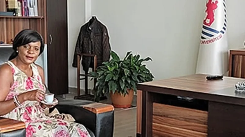 Makam odasında koltuklarda oturan iki konuk ile masanın başındaki ev sahibi.